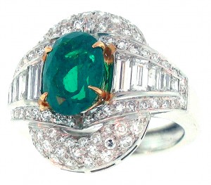 Fine emerald oval in heavy platinum and diamond ring
